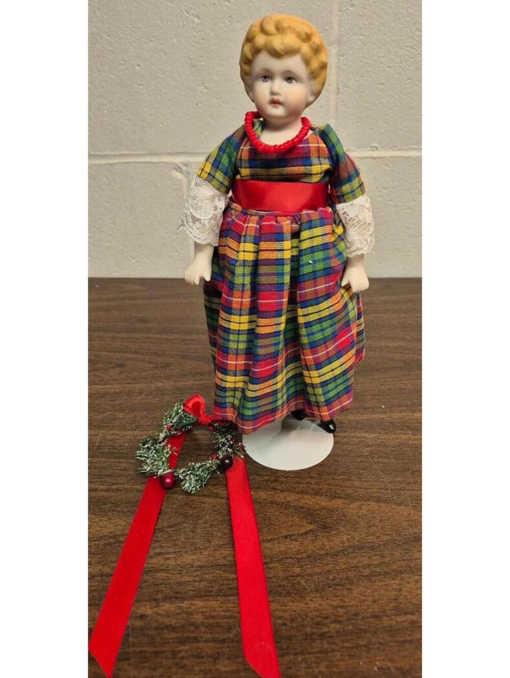 Vintage Porcelain Doll in Traditional Plaid Dress with Red Necklace